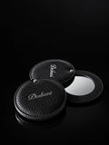 Deshani Compact Leather Mirror on a black background