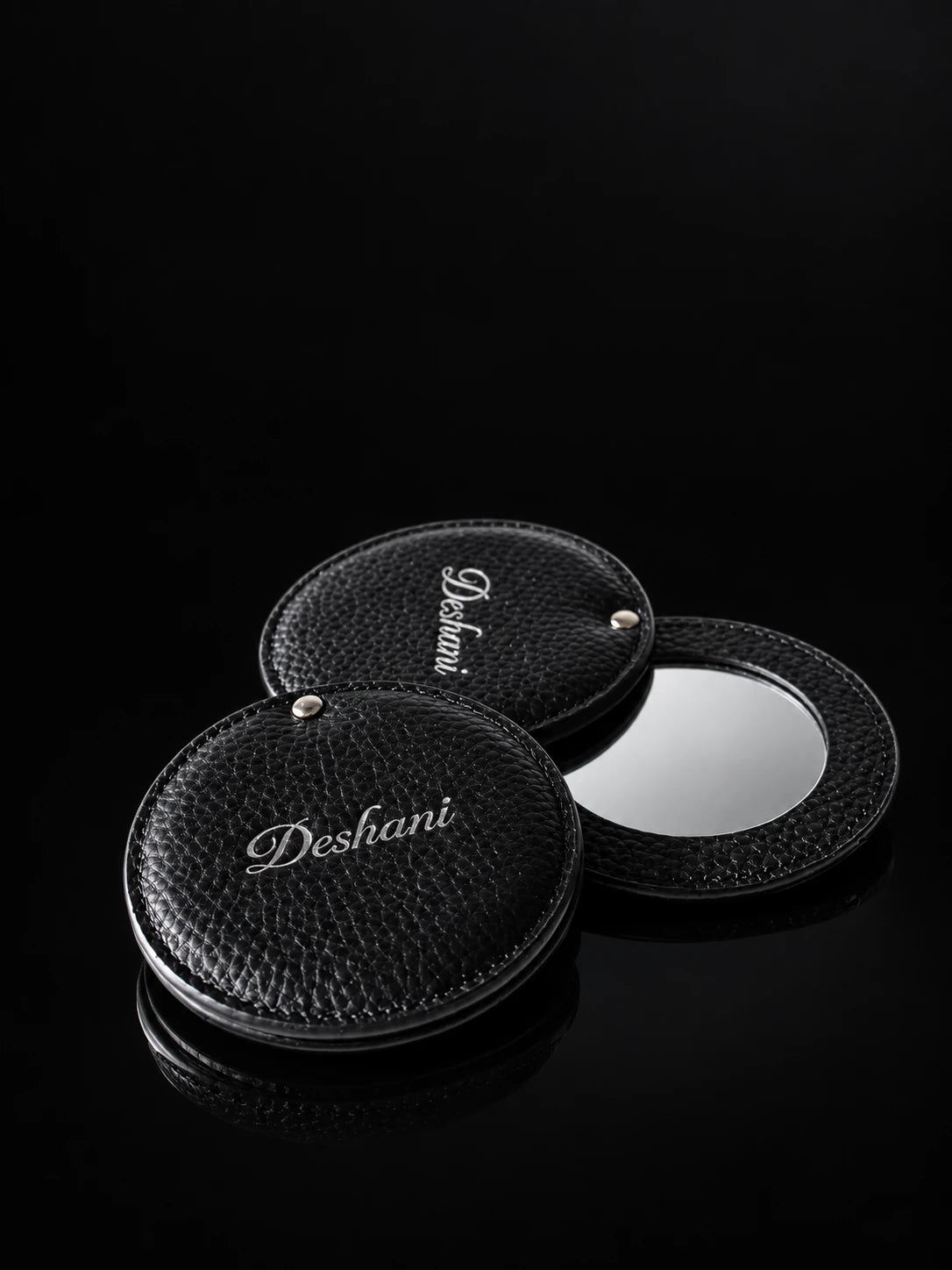 Deshani Compact Leather Mirror on a black background