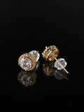 Gold CZ Starburst Stud Earrings on a black background