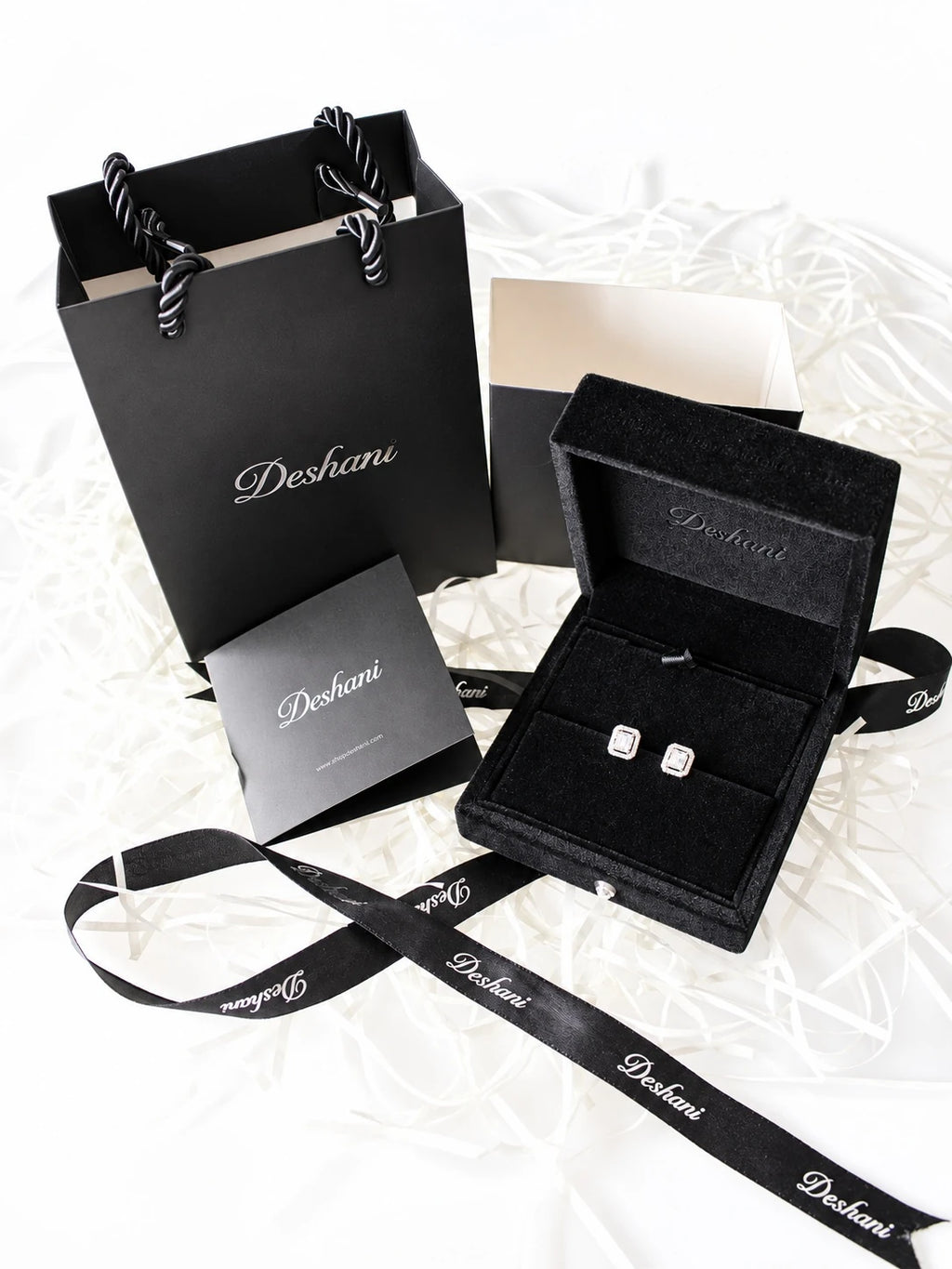 Gold Emerald-Cut Halo Studs in Deshani gift-ready packaging