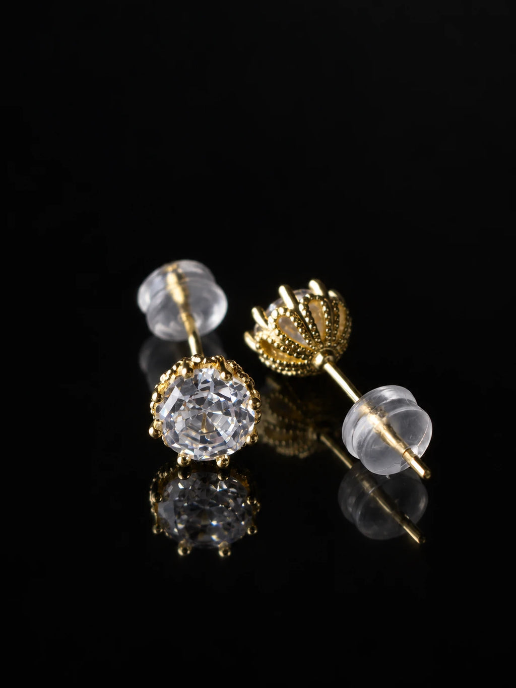Gold Crown Solitaire Studs on a black background