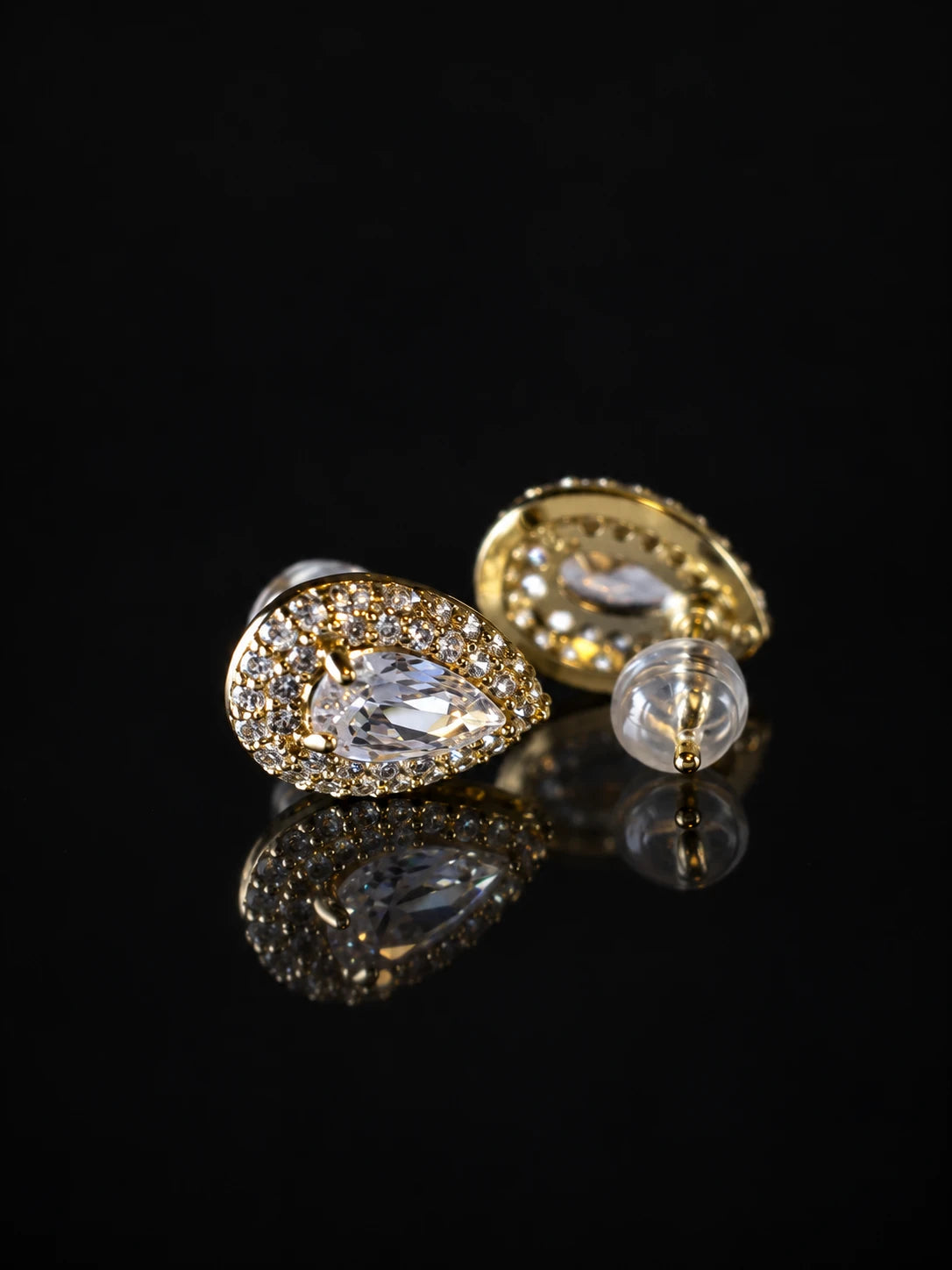 Gold Pear Halo Studs on a black background