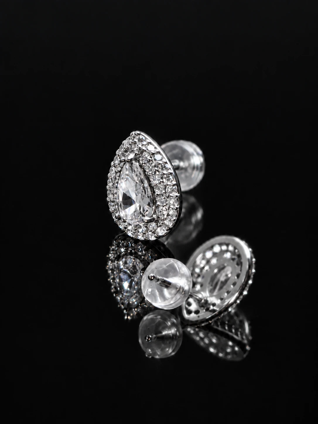 Silver Pear Halo Studs on a black background