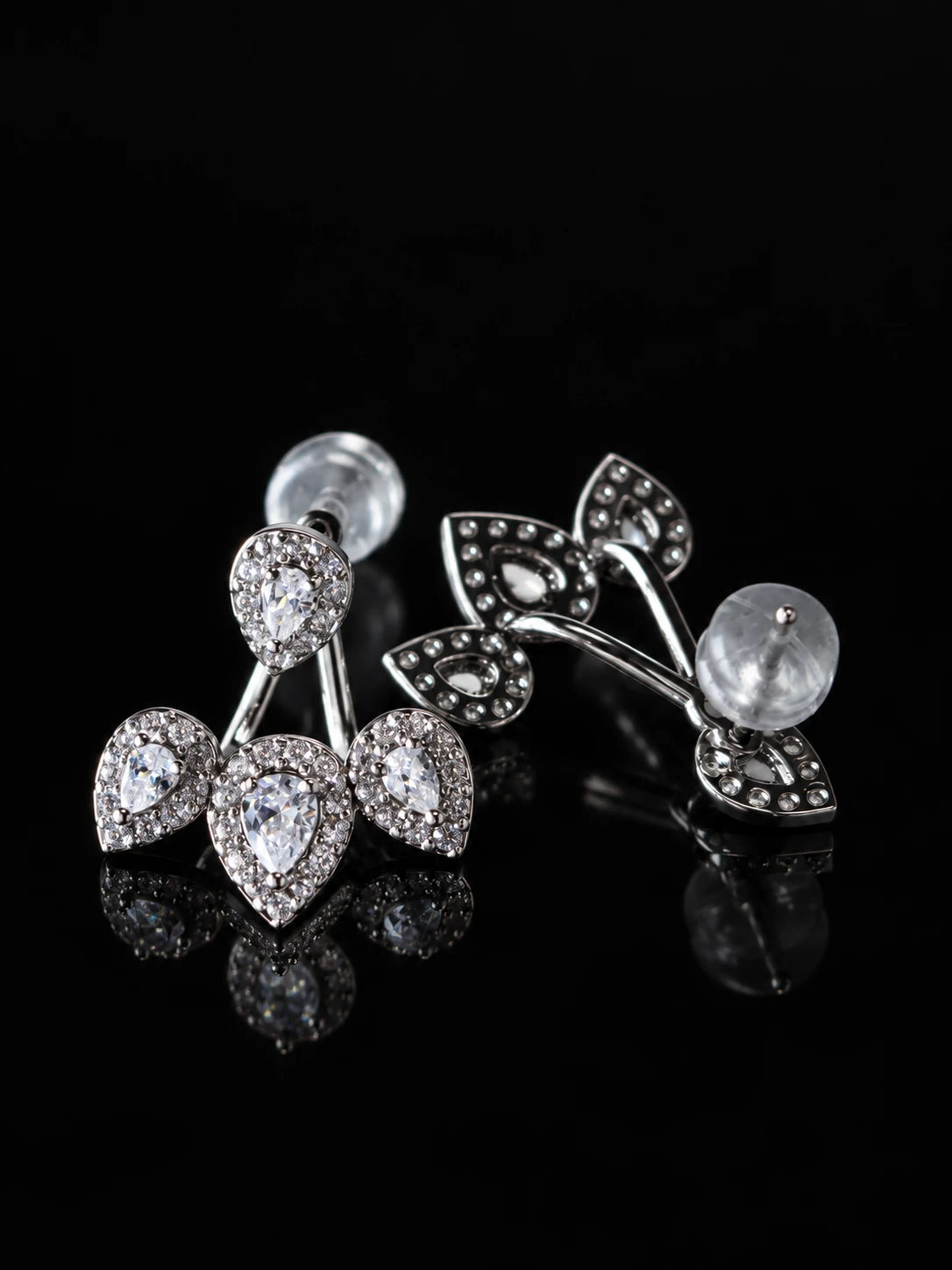Clear CZ Cherry Jacket Studs on a black background