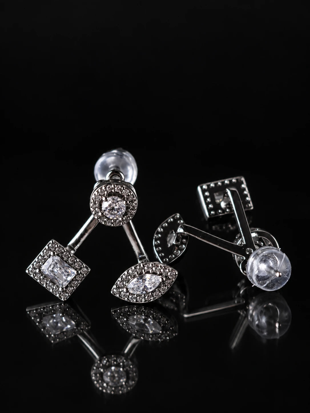 Black & Silver Mixed-Cut CZ Jacket Studs on a black background