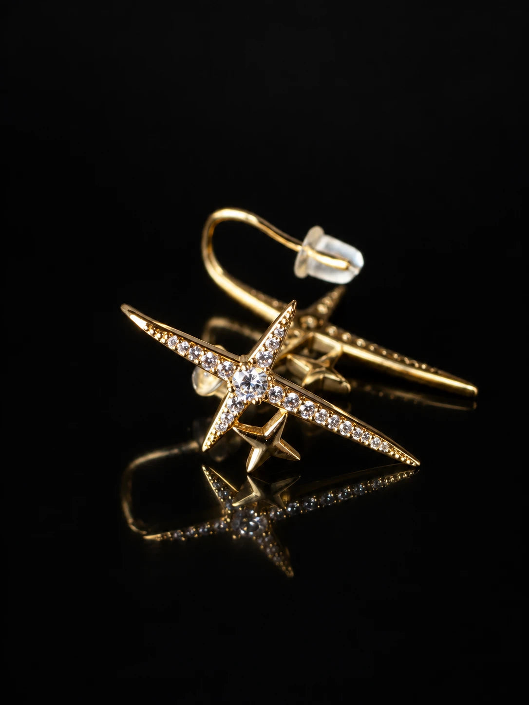 Gold Crossed Star Studs on a black background