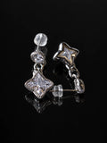 Silver Star Cushion Drops on a black background