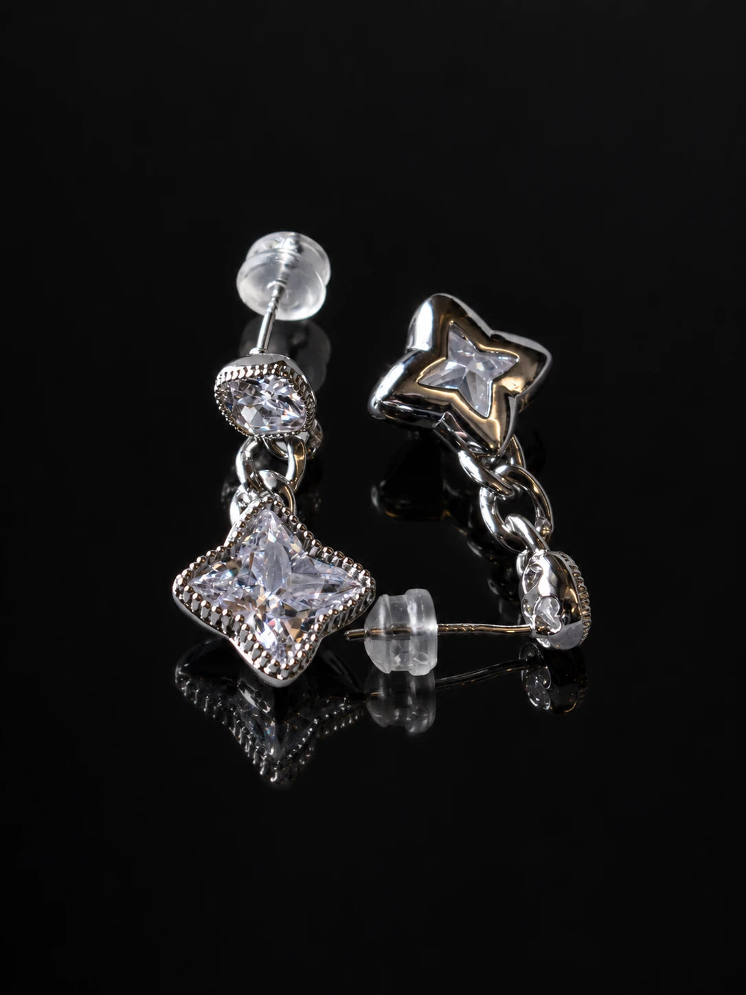 Silver Star Cushion Drops on a black background