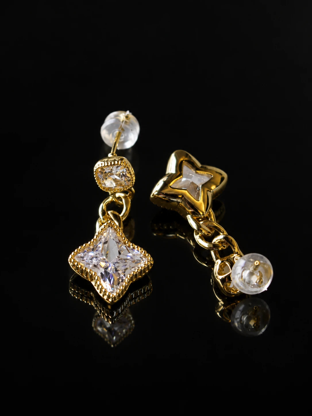 Gold Star Cushion Drops on a black background