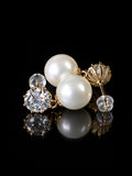 Gold Pearl Solitaire Studs on a black background