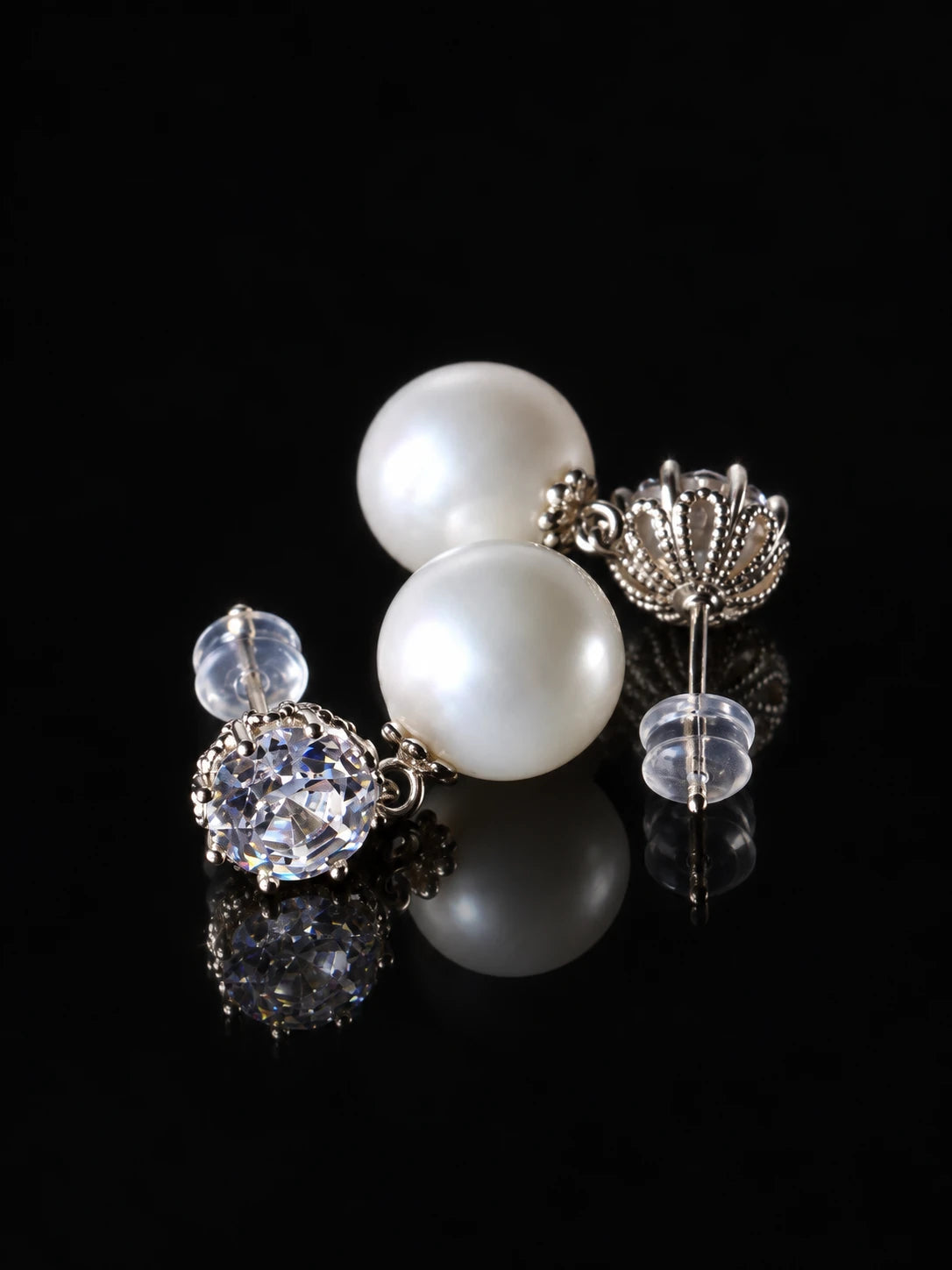 Silver Pearl Solitaire Studs on a black background