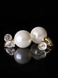 Gold Pearl Pear Accent Studs on a black background