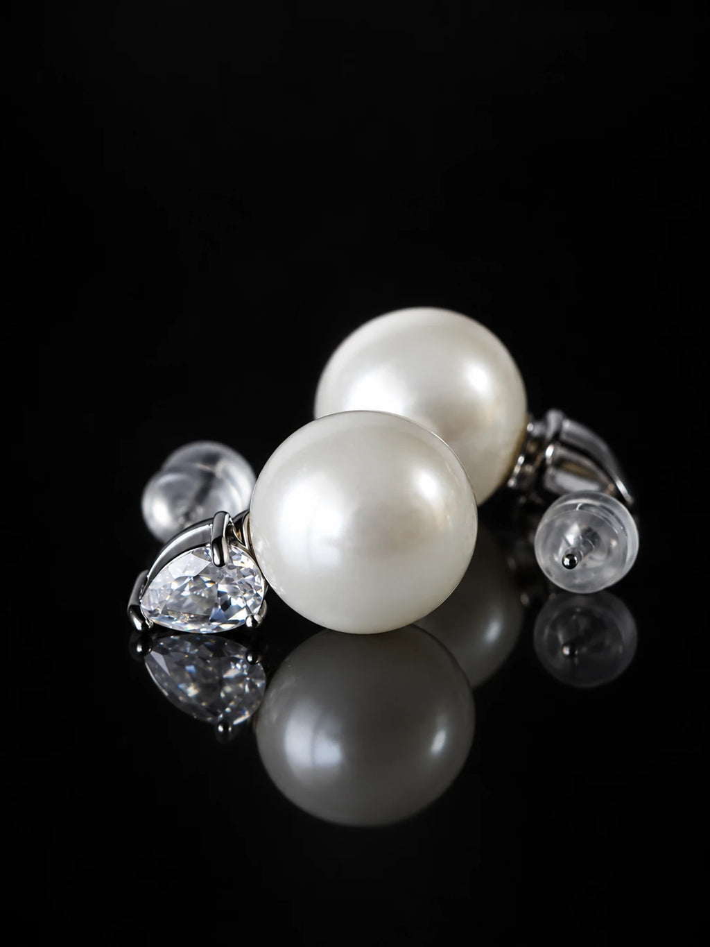 Gold Pearl Teardrop Studs on a black background
