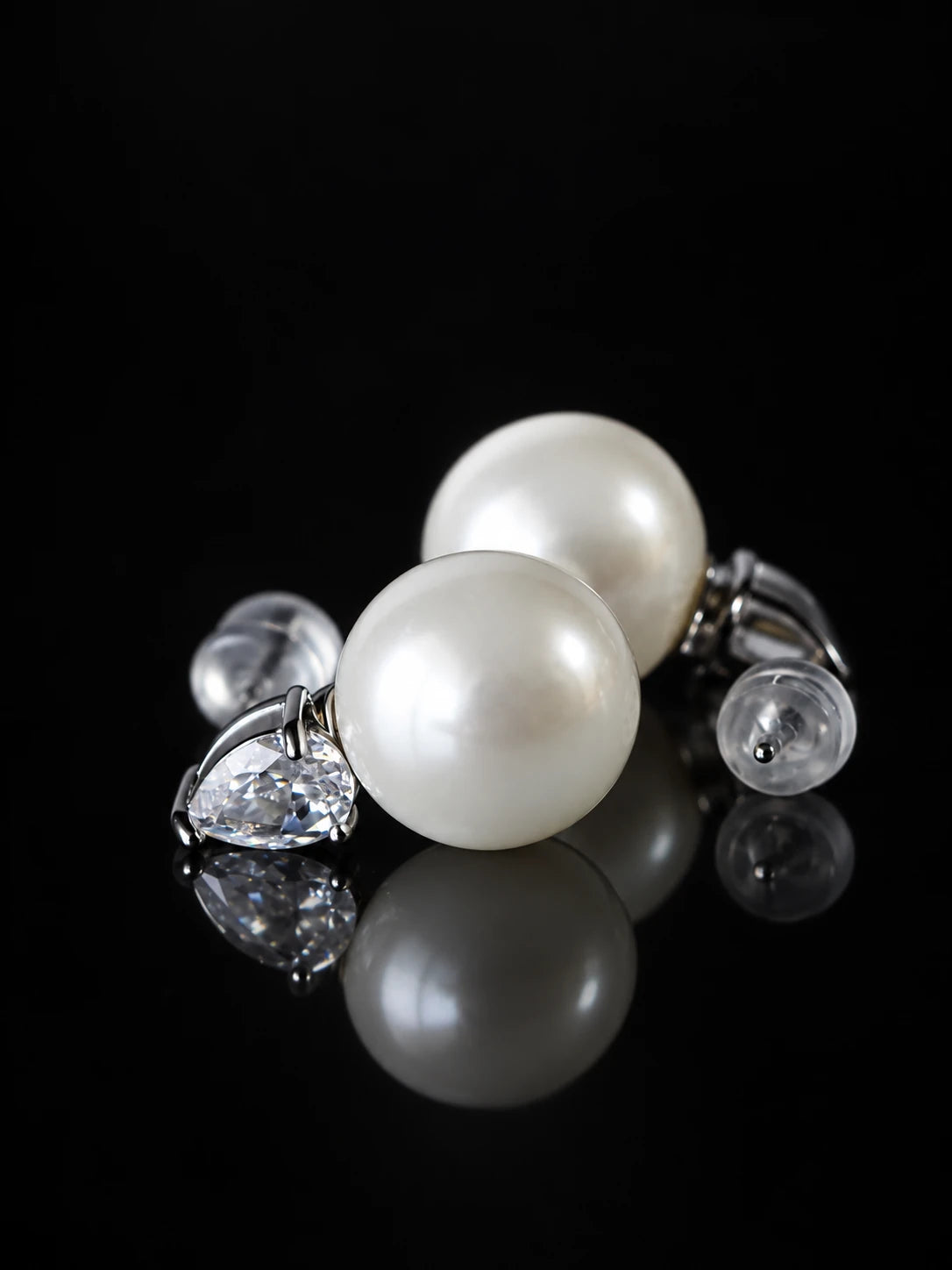 Gold Pearl Teardrop Studs on a black background