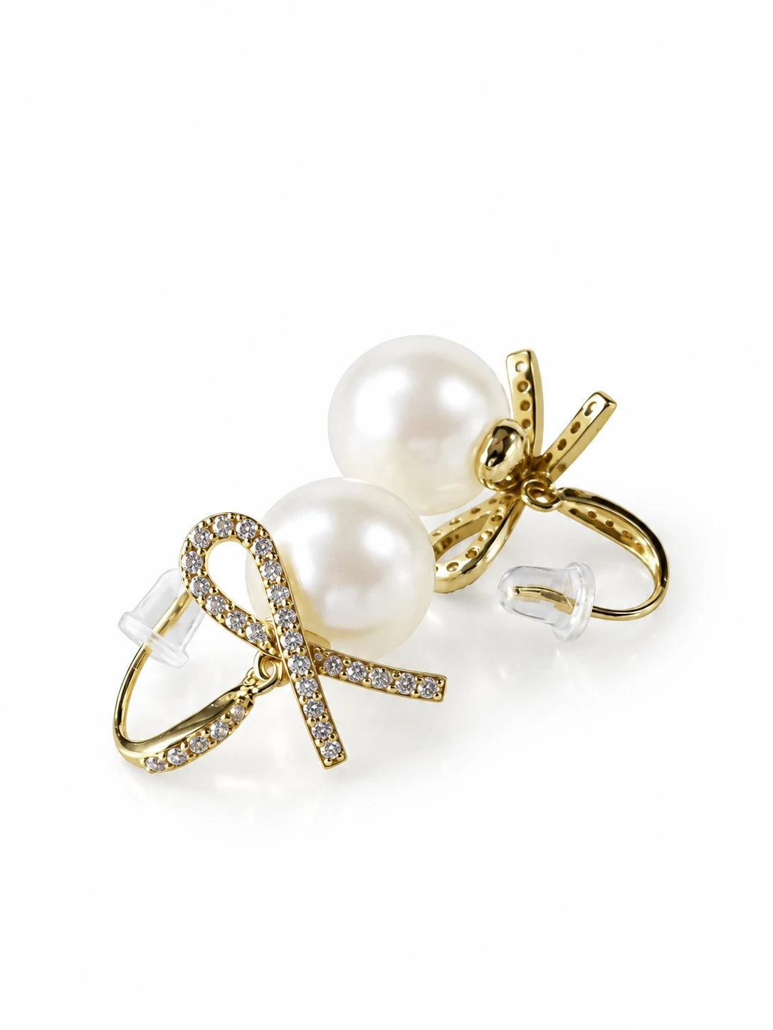 Gold Pearl Bow Studs on a white background