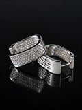 Silver Wide Pave Huggies on a black background