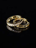 Gold Baguette Channel Hoops on a black background