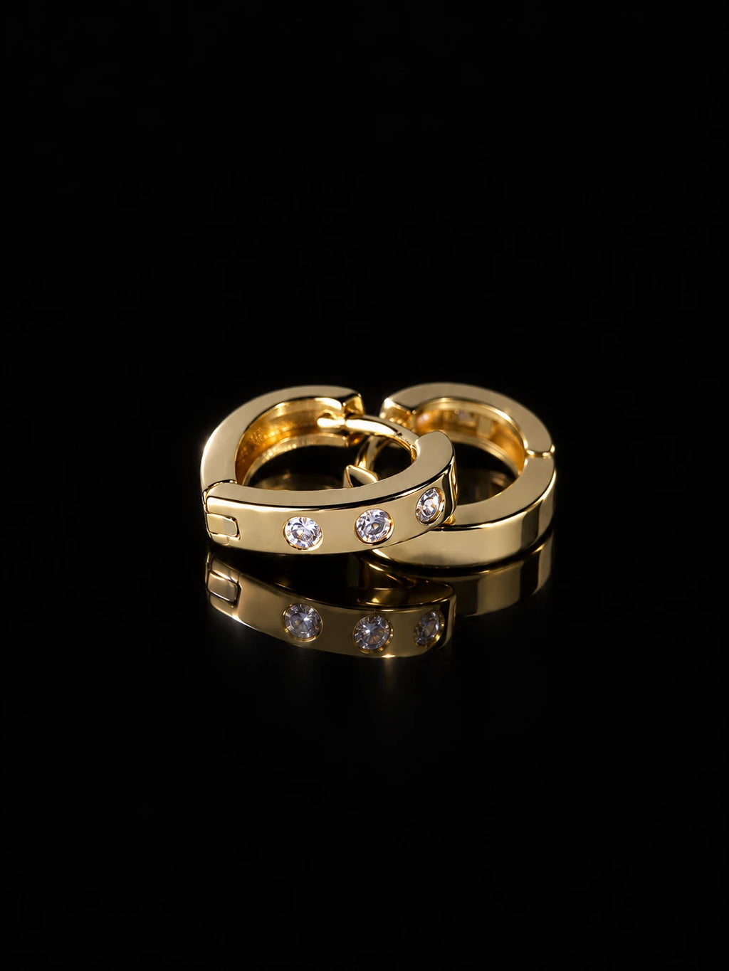 Gold Dot CZ Huggies on a black background
