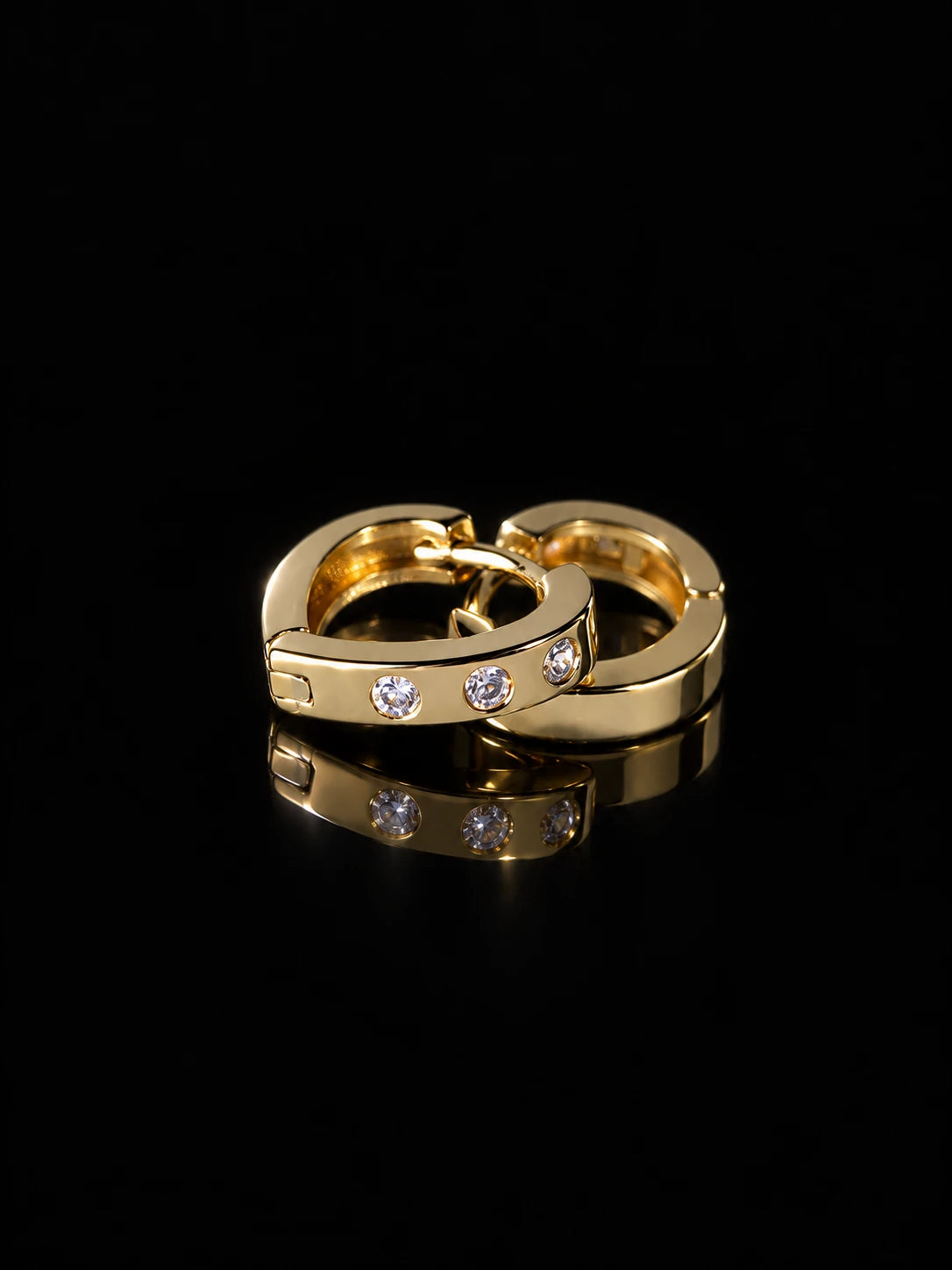 Gold Dot CZ Huggies on a black background