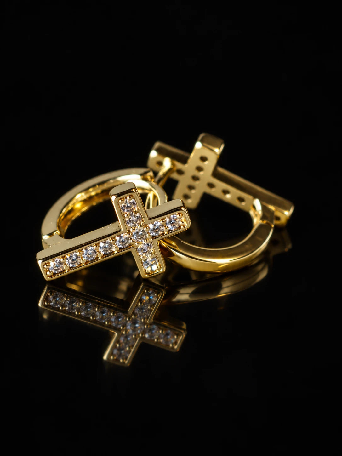 Gold Cross CZ Huggies on a black background