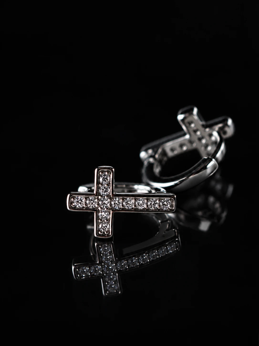 Black & Silver Cross CZ Huggies on a black background