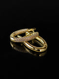 Gold Pave Oval Hoops on a black background