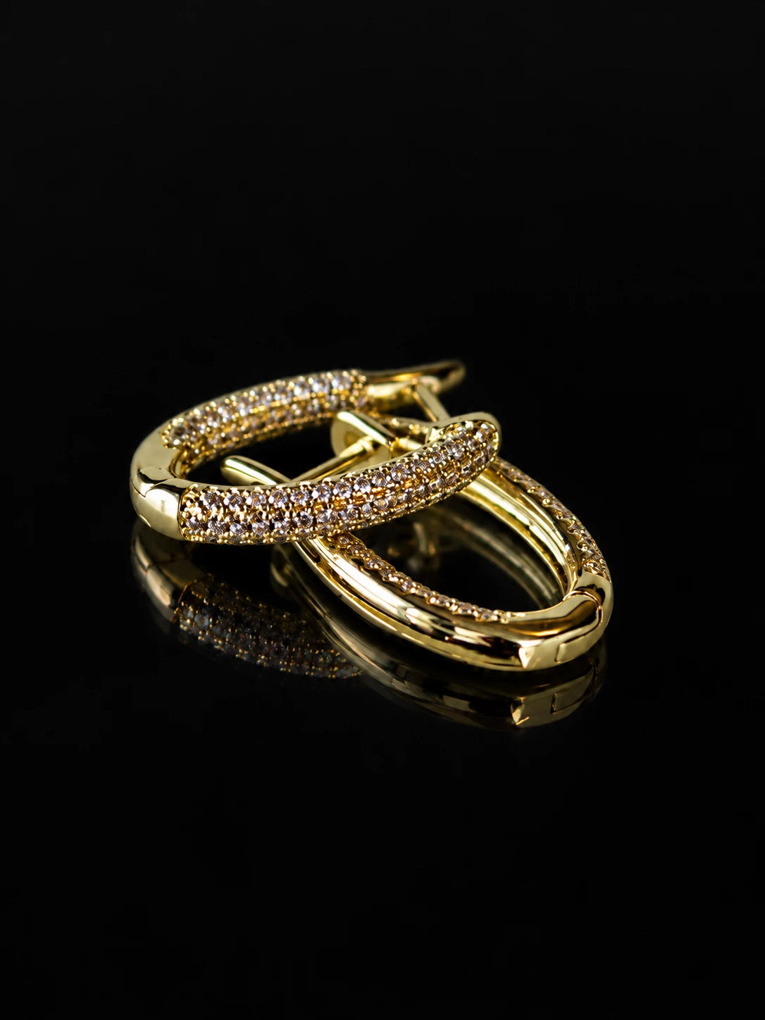 Gold Pave Oval Hoops on a black background