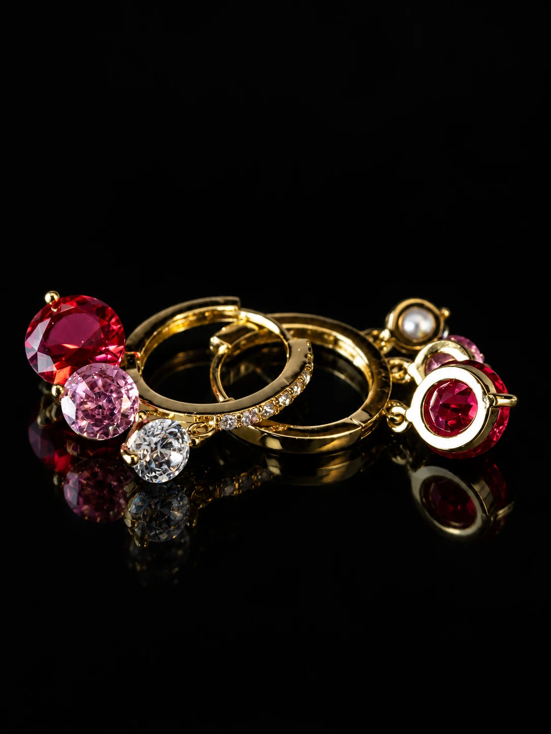Gold Ruby Charm Hoops on a black background