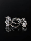 Silver Solitaire Charm Hoops on a black background