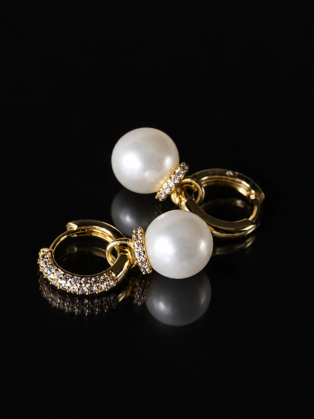 Gold Pearl Drop Hoops on a black background