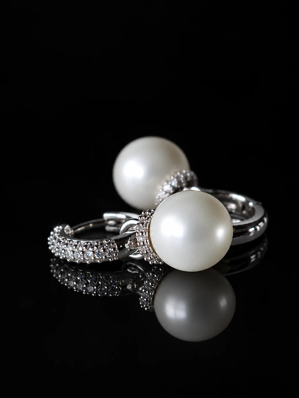 Silver Pearl Drop Hoops on a black background