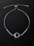 Green Solitaire Pavé Bracelet on a black background