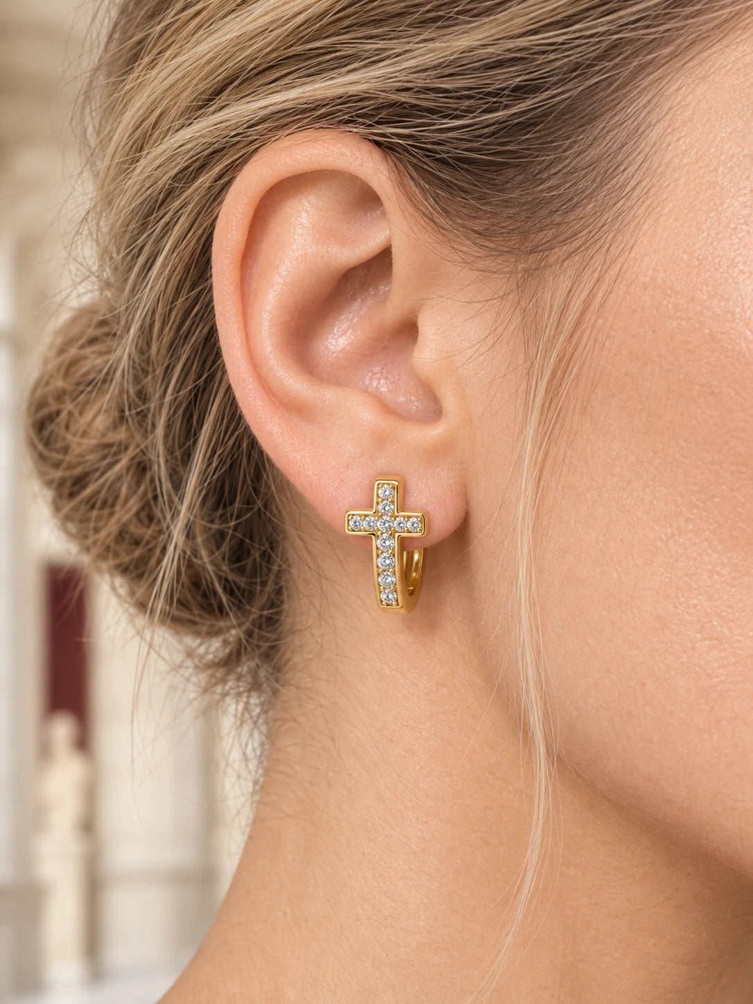 Close-up view of Gold Cross CZ Huggies