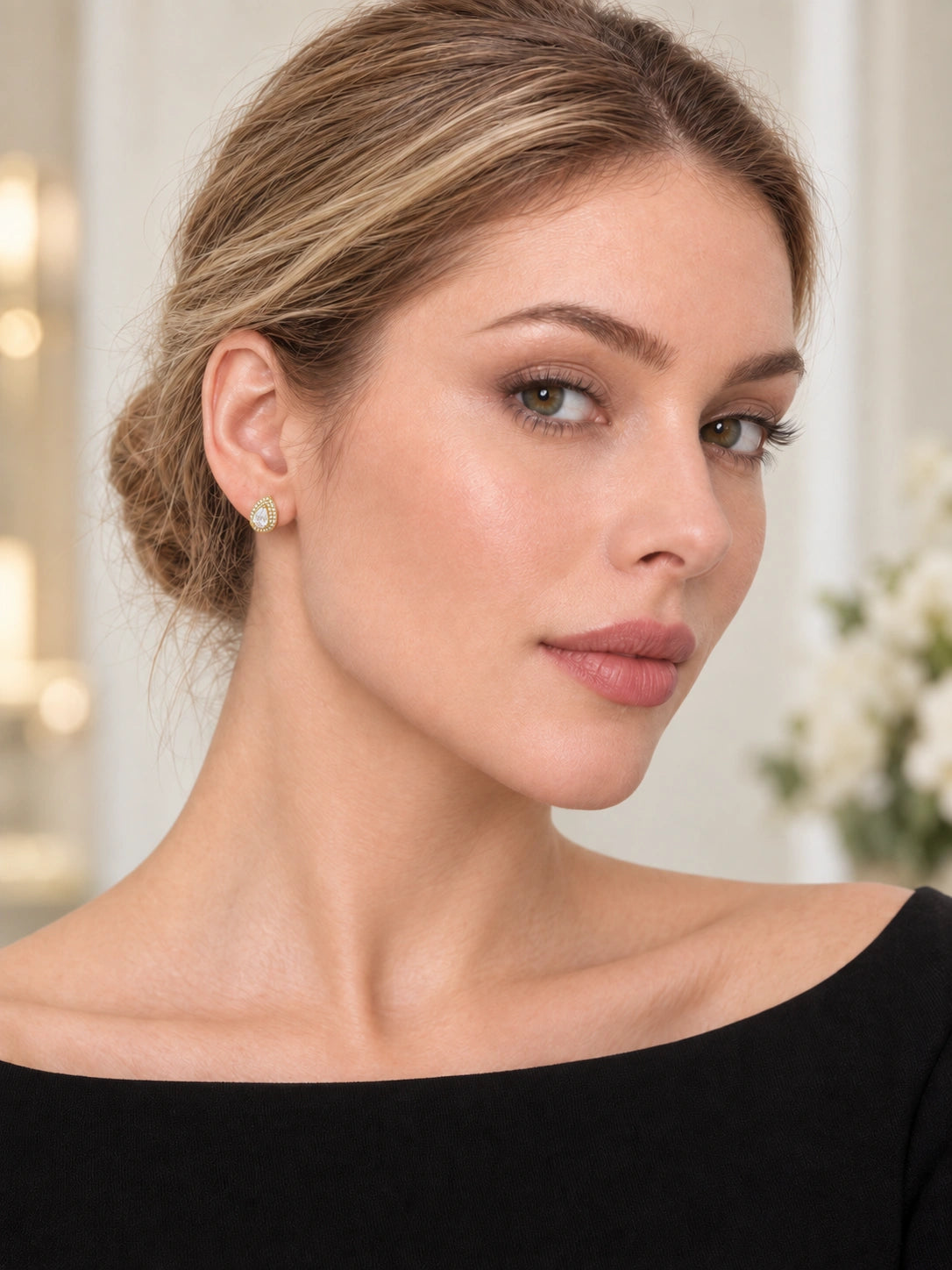Model wearing Gold Pear Halo Studs