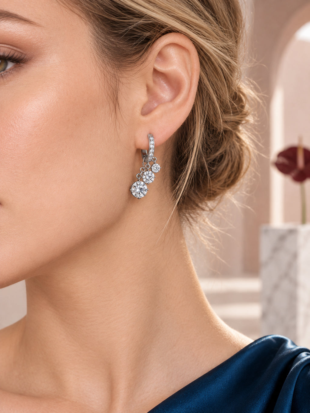 Close-up of Silver Solitaire Charm Hoops being worn