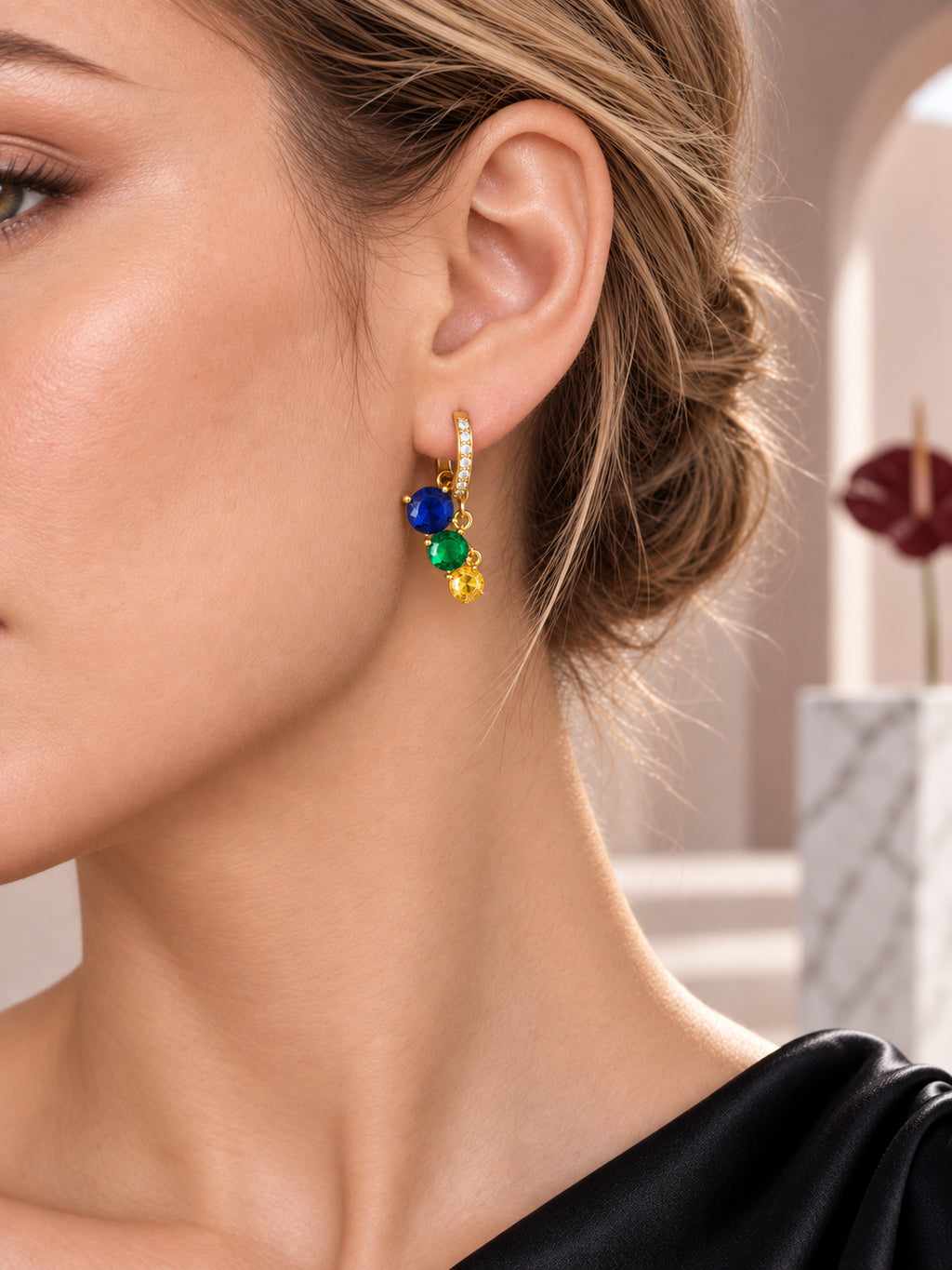 Close-up of Gold Sapphire Charm Hoops being worn